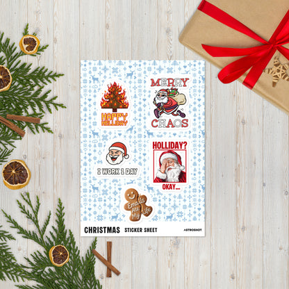 Funny Christmas sticker sheet featuring Happy Helliday burning tree, Merry Chaos Santa, and Emails Ate My Life gingerbread man