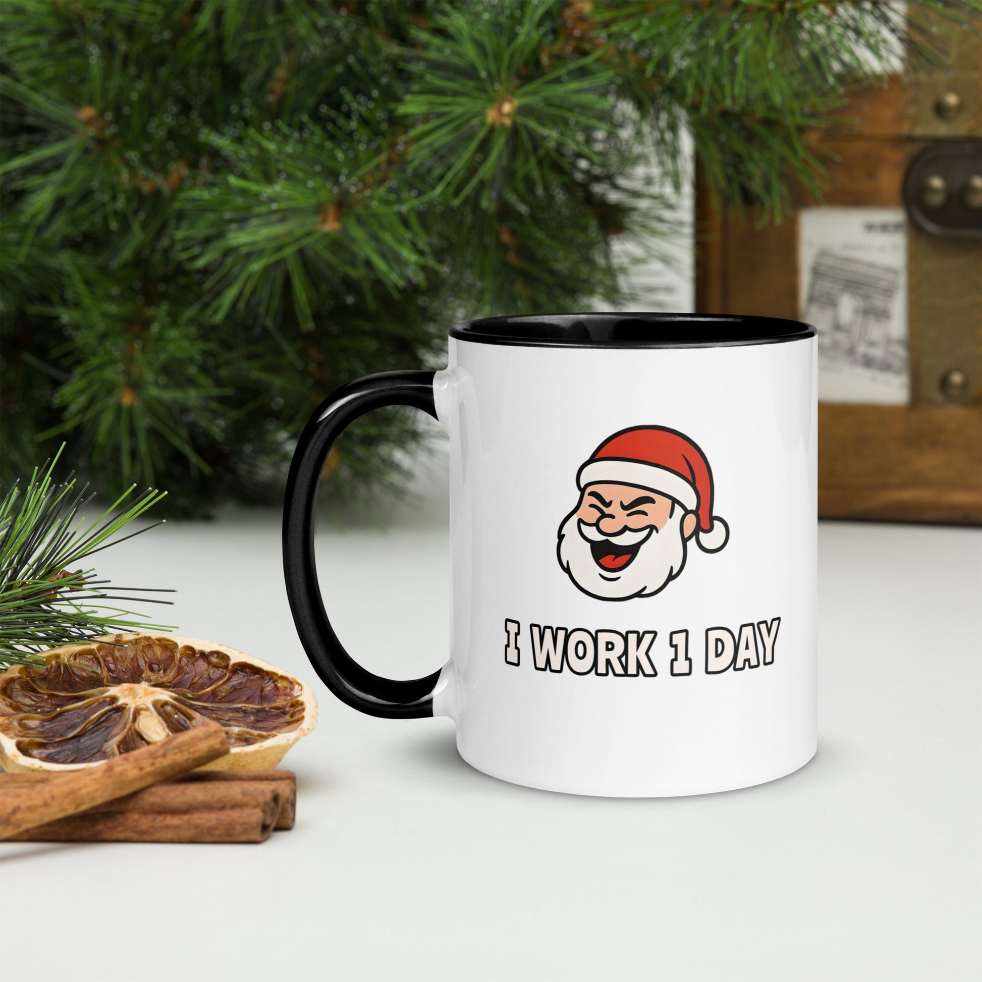 White ceramic mug with color inside featuring winking Santa Claus face and "I WORK 1 DAY" text