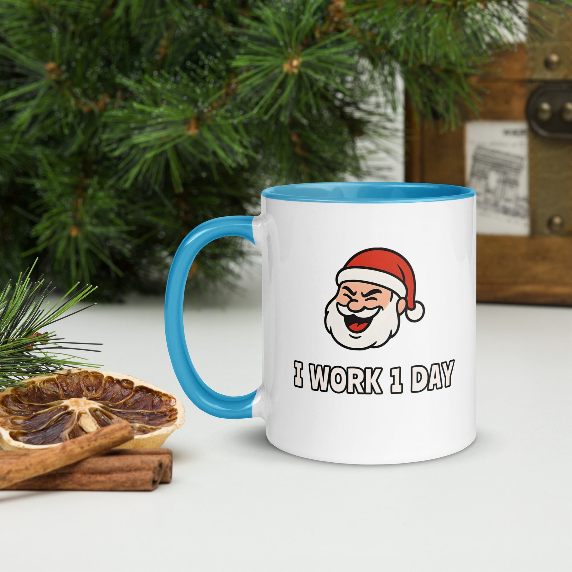 White ceramic mug with color inside featuring winking Santa Claus face and "I WORK 1 DAY" text