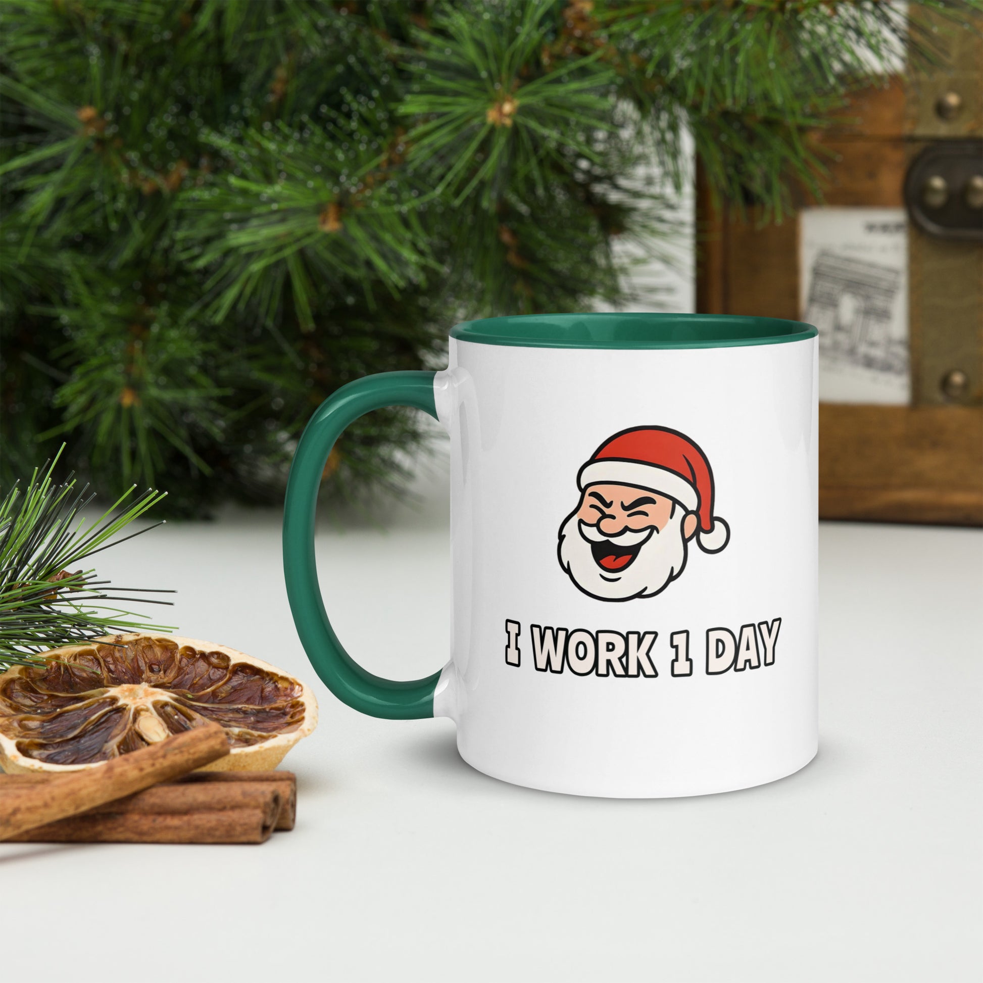 White ceramic mug with color inside featuring winking Santa Claus face and "I WORK 1 DAY" text