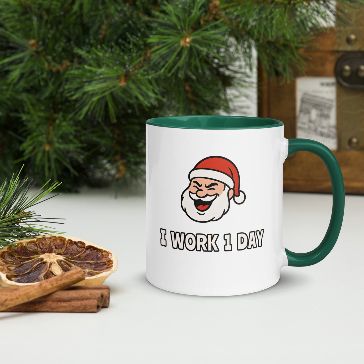 White ceramic mug with color inside featuring winking Santa Claus face and "I WORK 1 DAY" text