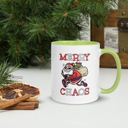 White ceramic mug with color inside featuring funny running Santa Claus and "MERRY CHAOS" text