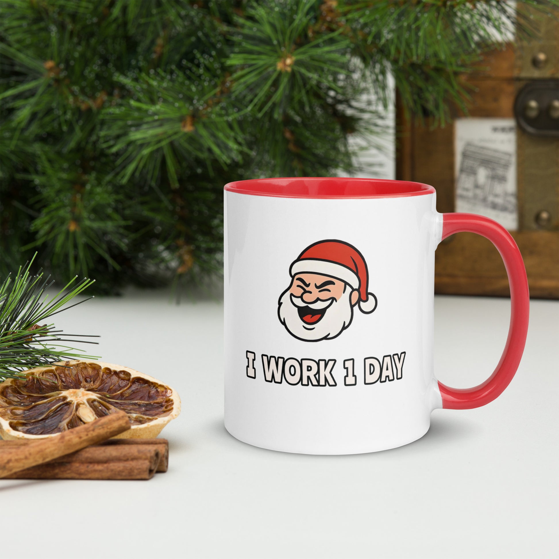 White ceramic mug with color inside featuring winking Santa Claus face and "I WORK 1 DAY" text